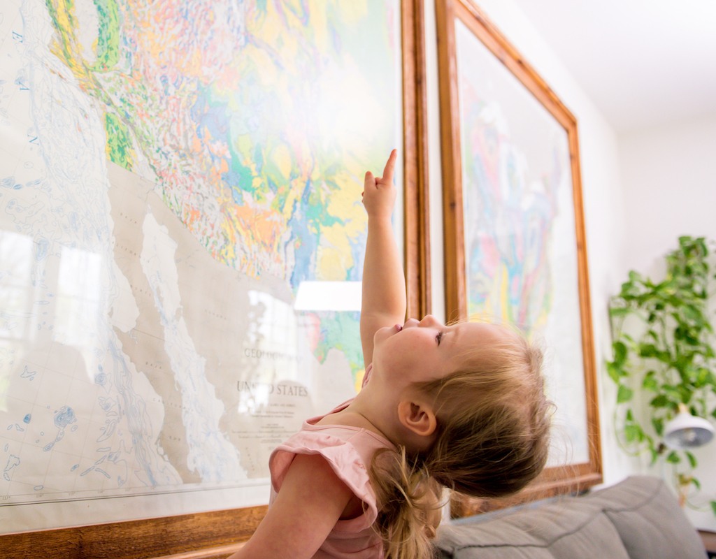 Toddler looking at United States map